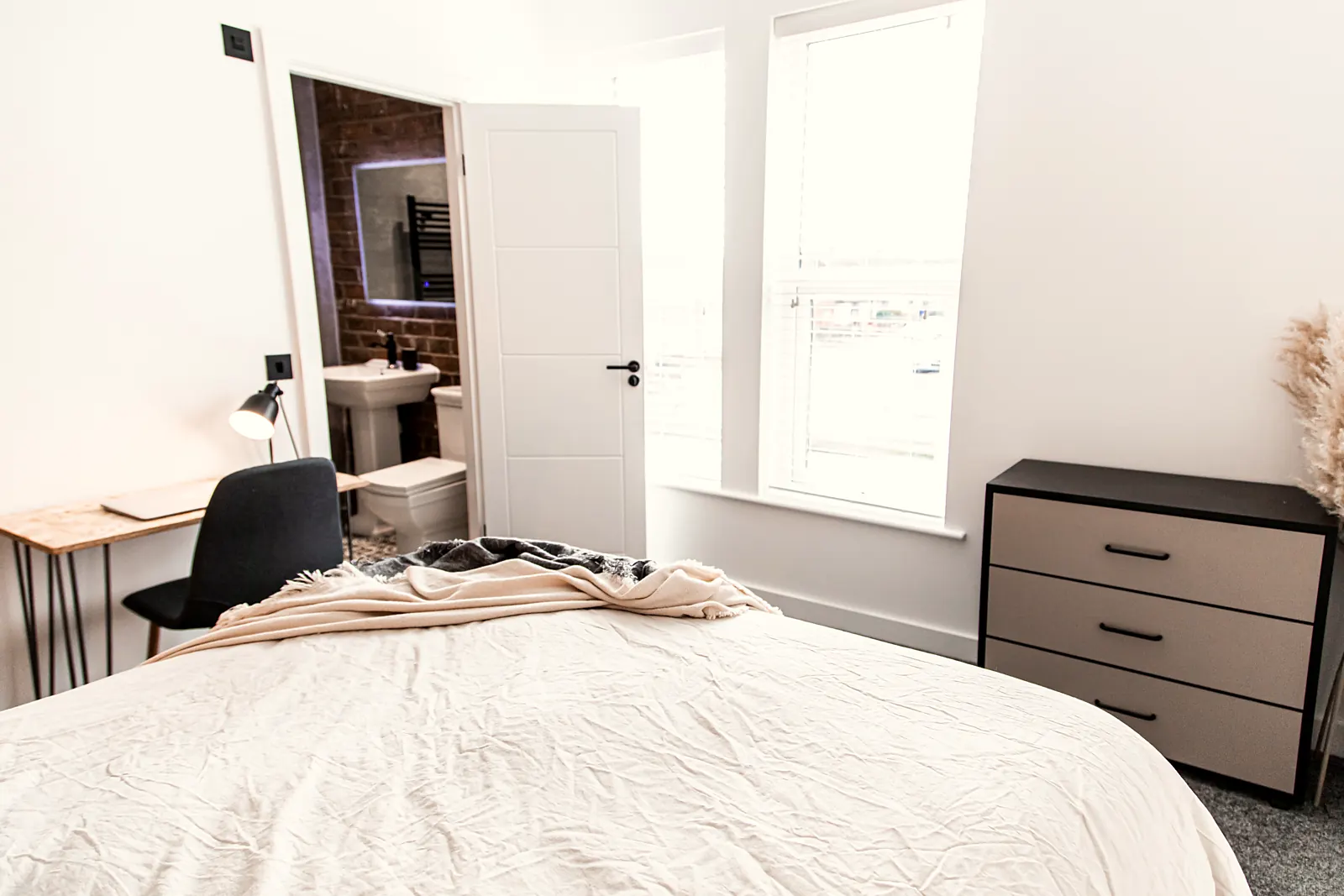 Bright furnished double bedroom with a desk in a Tameside house share