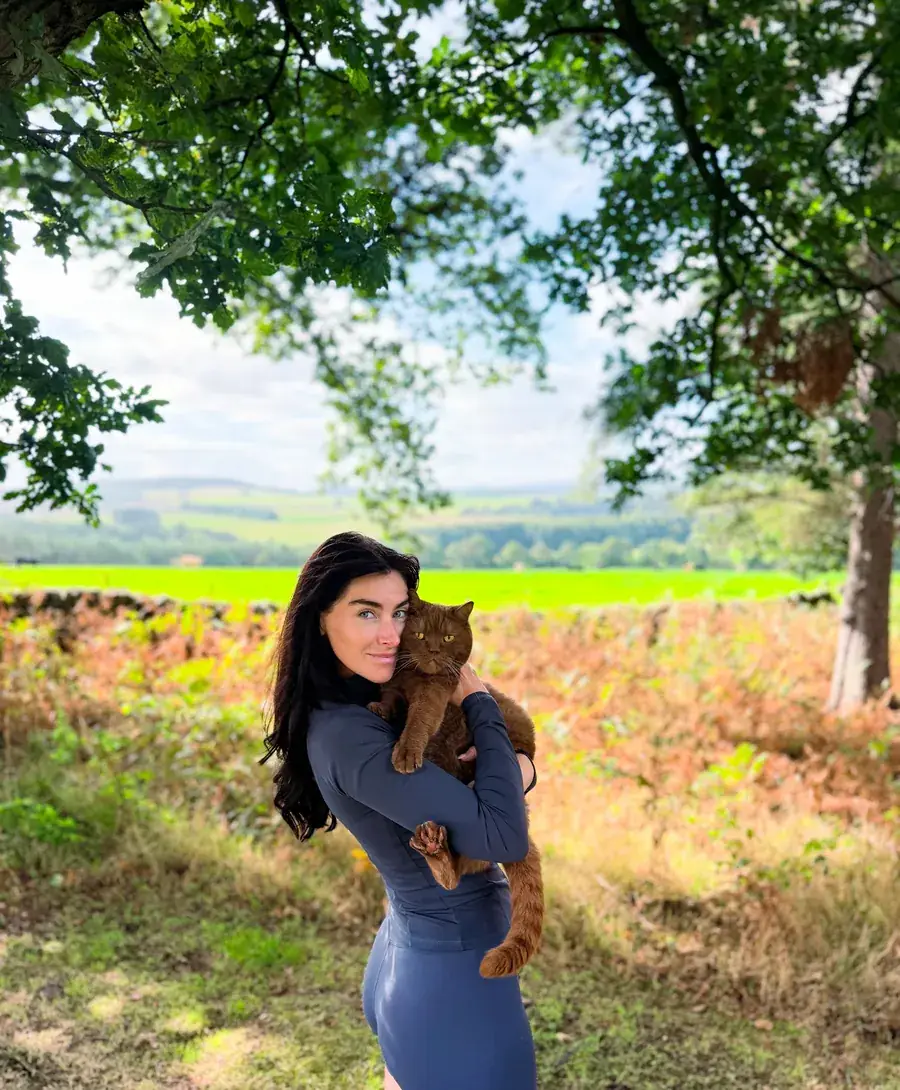 Josie Bentley with Hugo the cat in the countryside
